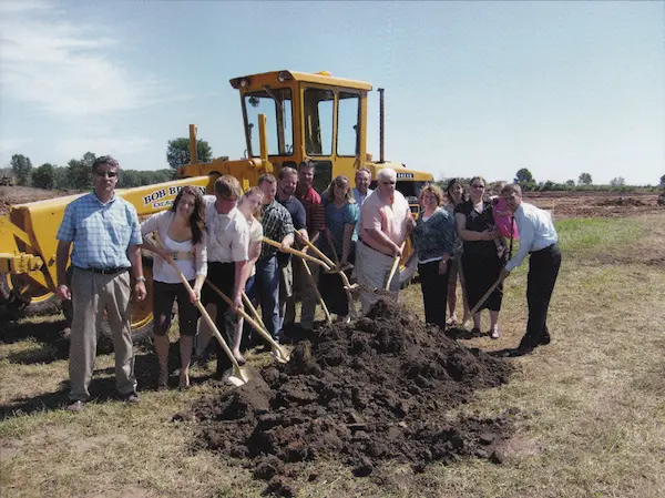 Employees breaking ground for new building in 2012 